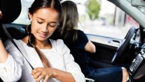 girl-fastening-safety-belt-300x169